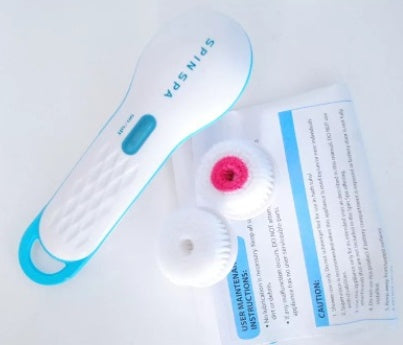 Nettoyant Électrique pour le Visage avec brosse de rechange et instructions d'utilisation.